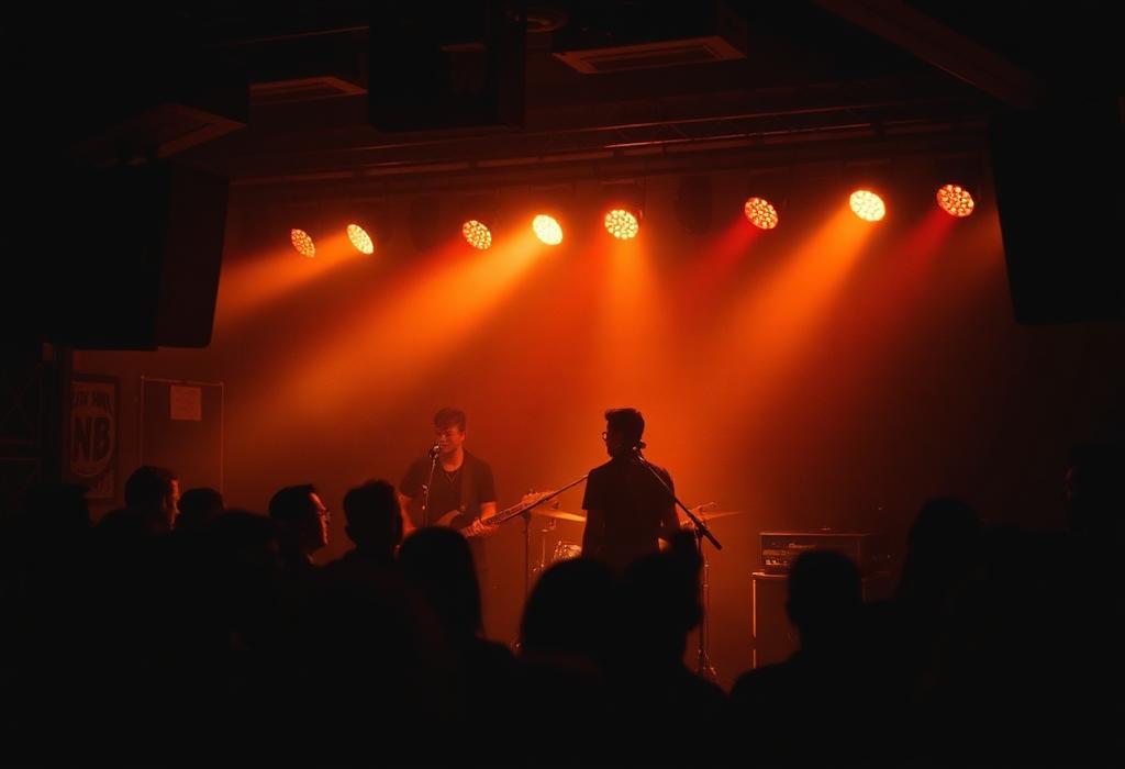 Small live music venue with a band on stage in amber light